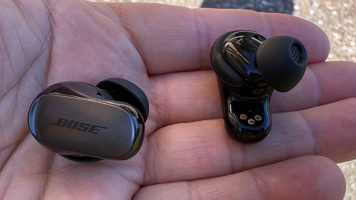 Hand holding Bose's QuietComfort Ultra (2nd Gen) earbuds.