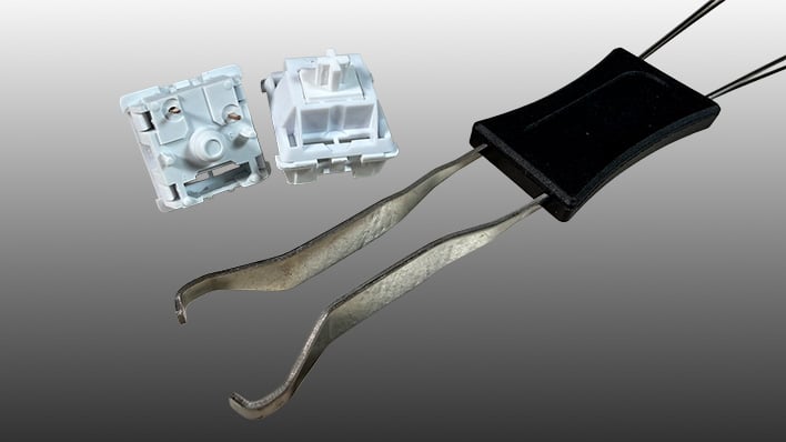 Feker Marble White key switches next to a key puller on a gray gradient background.