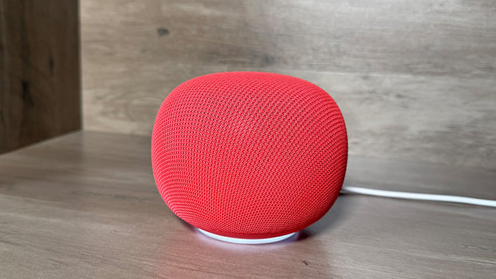 Google Home Speaker (side view) on a bookshelf.