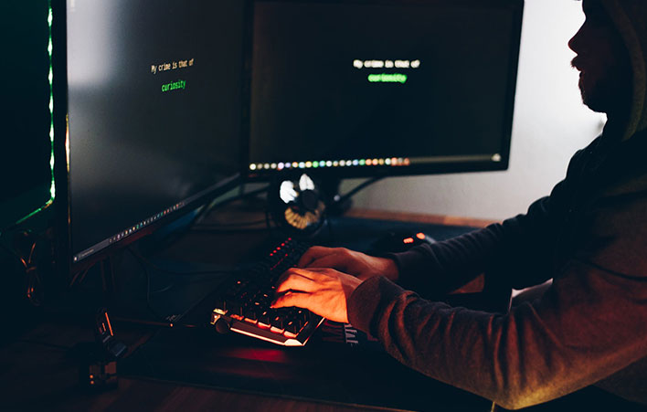hacker typing on keyboard and hacking