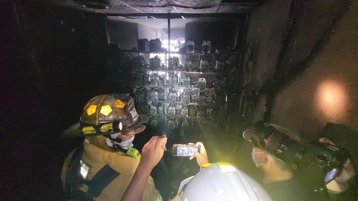 firefighters examine burned crypto mining servers