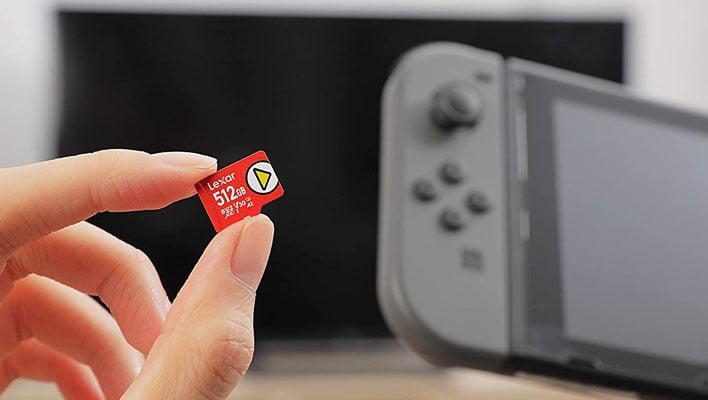 Lexar 512GB microSD card in hand in front of a Switch console.
