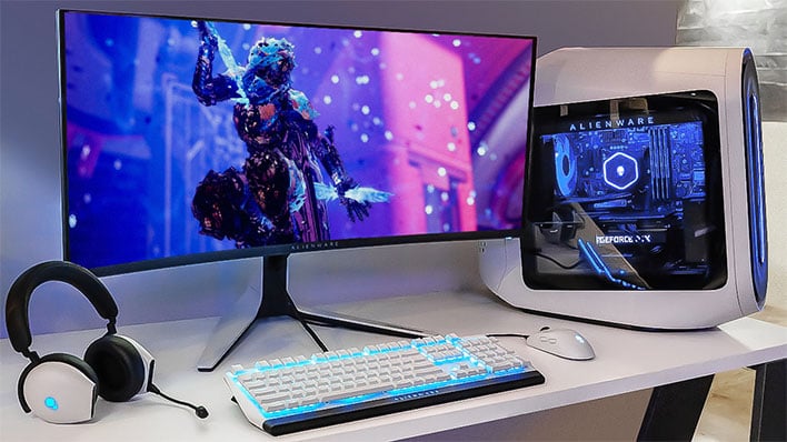 Dell Alienare 34 QD-OLED gaming monitor on a desk next to a PC.