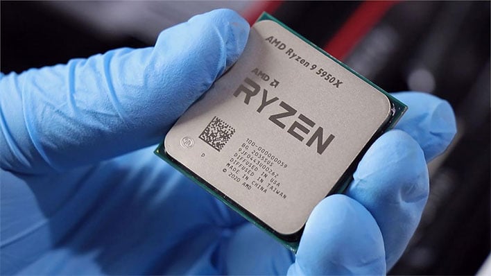Ryzen 9 5950X CPU in hand with a blue glove on