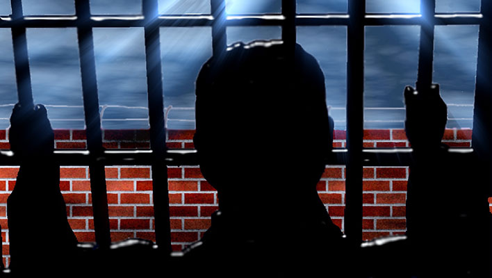 Person behind bars (jail)