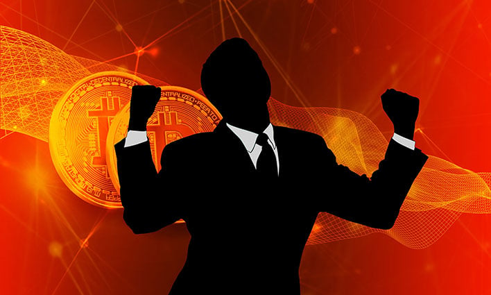 Silhouette of a man in front of a Bitcoin image