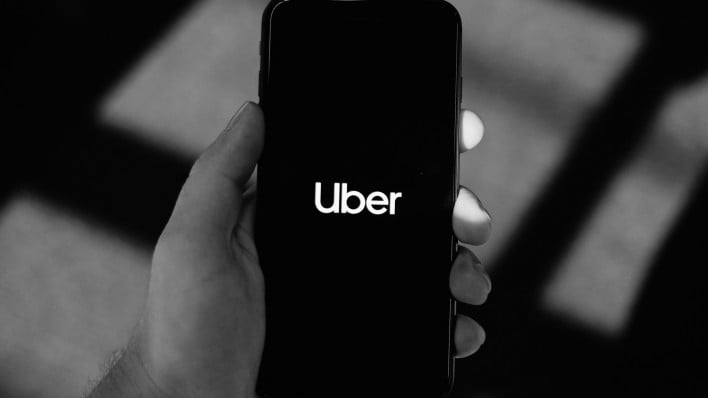 uber app on phone in hand news