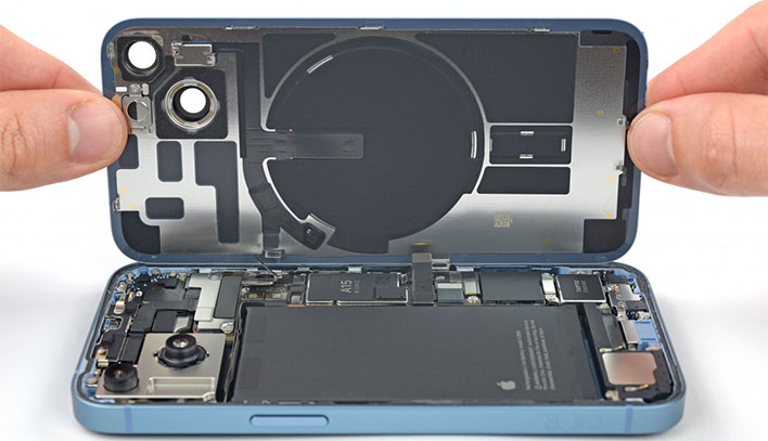 Apple iPhone 14 with its bottom cover lifted up exposing the internal hardware.