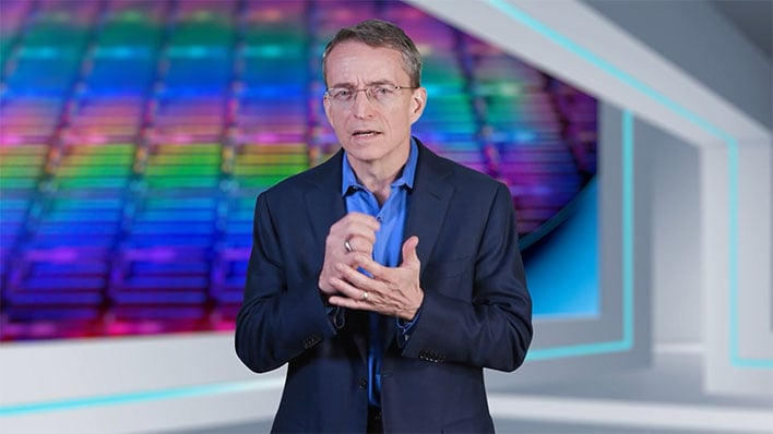 Intel CEO Pat Gelsinger standing in front of an image of a CPU wafer die shot.