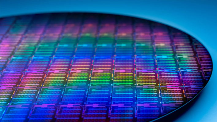 Closeup of a colorful Intel wafer on a blue background.