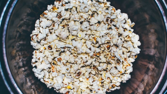 downward shot looking into popcorn tin news