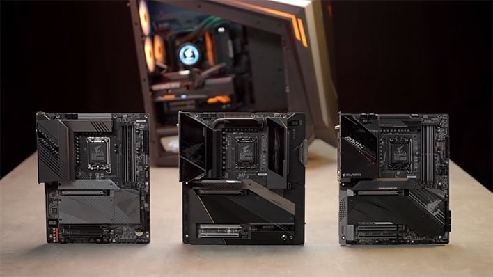 Three Gigabyte Z690 motherboards in front of an Aorus gaming PC.