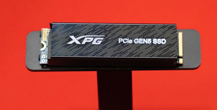Closeup of Adata's XPG PCIe Gen 5 SSD on a red background.