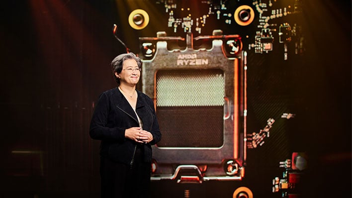 AMD CEO Dr. Lisa Su on stage in front of an image of a Ryzen CPU socket.