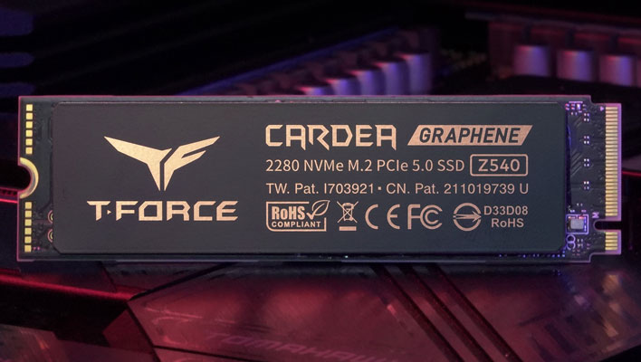 TeamGroup's T-Force Cardea Z540 SSD in front of a blurred motherboard in the background.