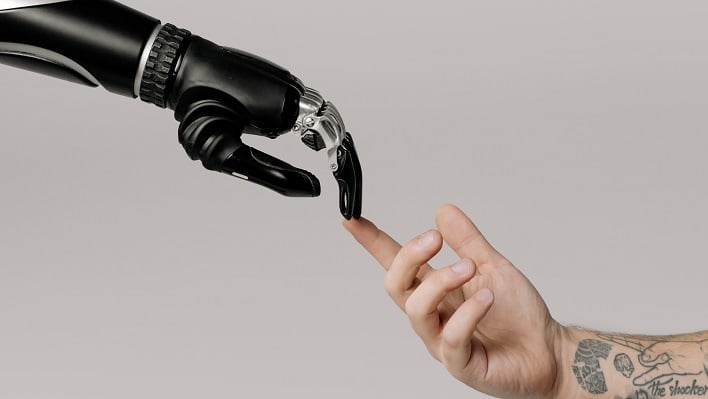 hero robot hand touching human hand