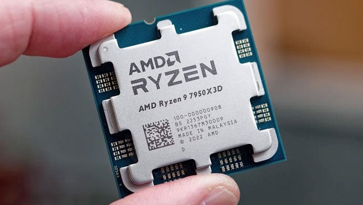 Fingers holding a Ryzen 9 7950X3D CPU