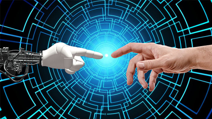 A robot finger and human finger about to touch.