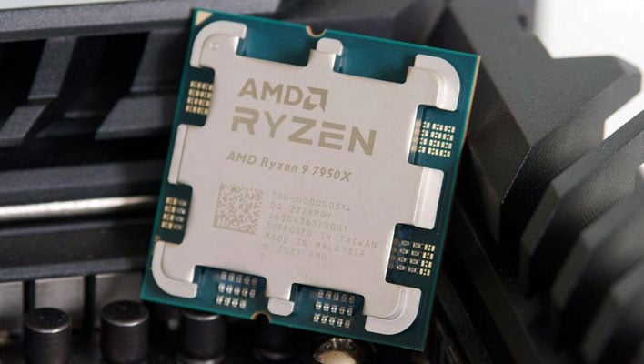 AMD Ryzen 9 7950X CPU leaning against a VRM heatsink in a motherboard.