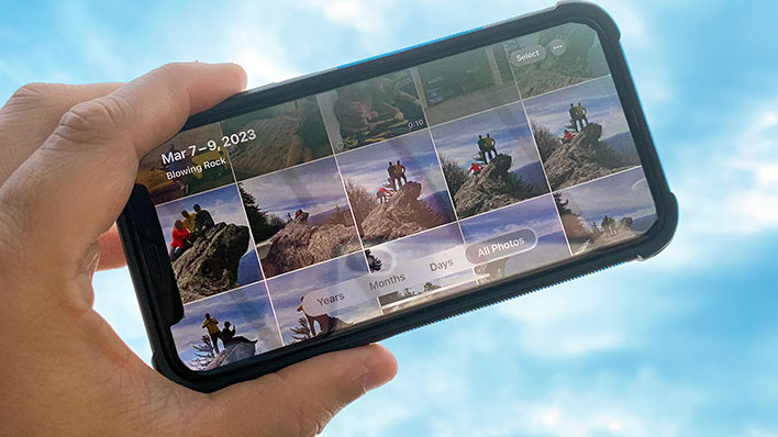 Holding an iPhone in front of the sky with the Photos album open