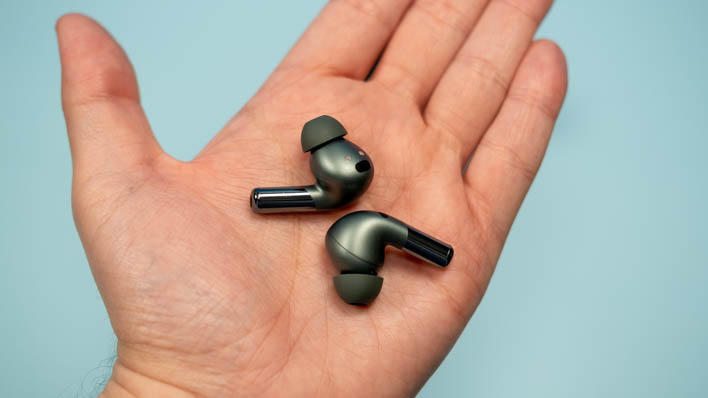 OnePlus Buds Pro 2 earbuds in the palm of a hand.