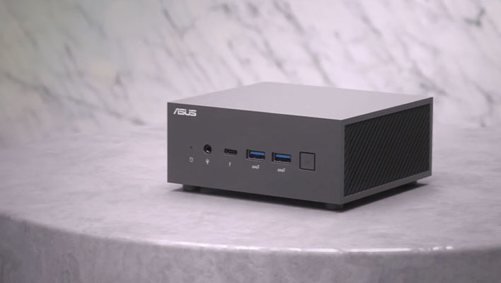 ASUS ExpertCenter mini PC on a marble pedestal in front of a marble wall.