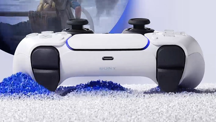 Sony's DualSense controller on white and blue gravel.