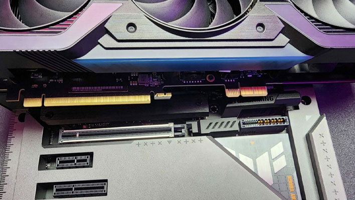 Closeup of the ASUS GeForce RTX 4070's special connector and accompanying slot on the motherboard.