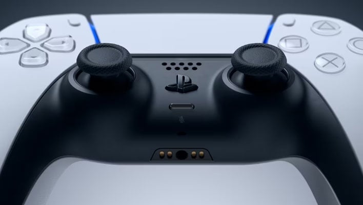 Closeup of a Sony DualSense controller on a gray background.
