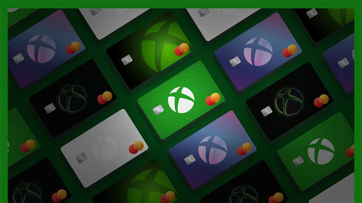 Several Xbox Mastercards angled on a dark green background.
