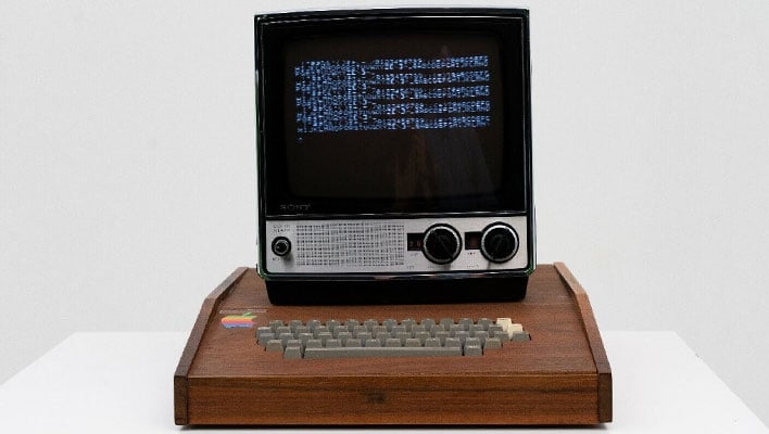 Apple-1 computer with monitor on a table.