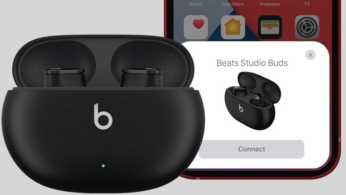 Charging case with Beats Studio Buds being paired to an iPhone.