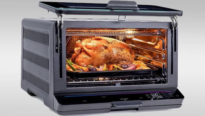 GE Profile Smart Oven with a turkey inside, on a gray gradient background.