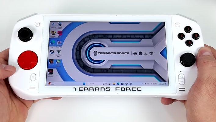 Man holding a Terrans Force 5 gaming handheld console.