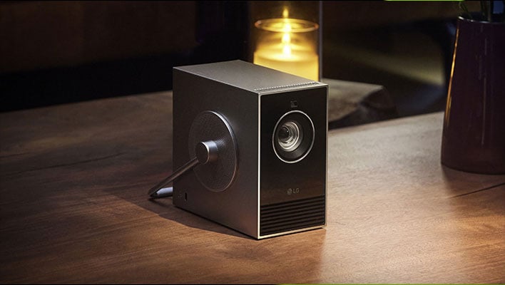 LG's CineBeam Qube projector on a wooden surface.