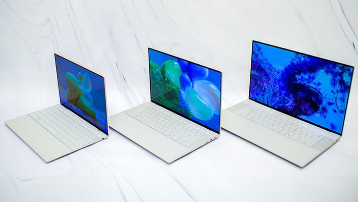 Three Dell XPS laptops (16, 14, and 13) on a white marble background.