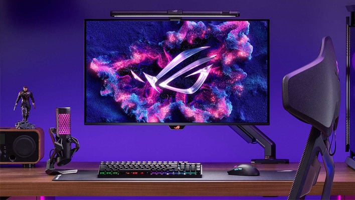 ASUS ROG OLED gaming monitor on a desk.