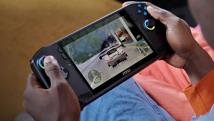 Holding an MSI Claw gaming handheld and playing a racing game.