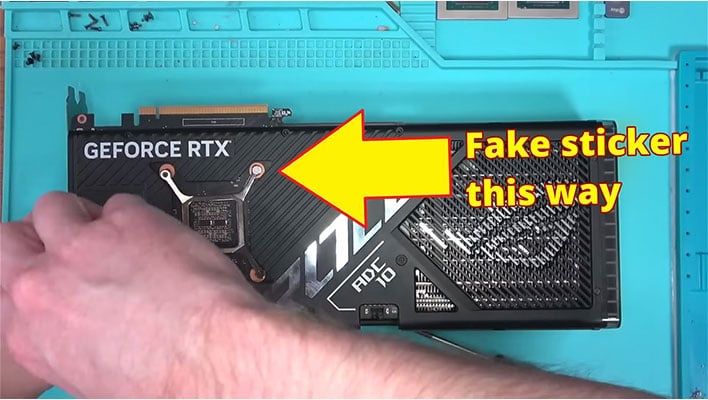 Repair shop owner holding a fake GeForce RTX 4090 graphics card.