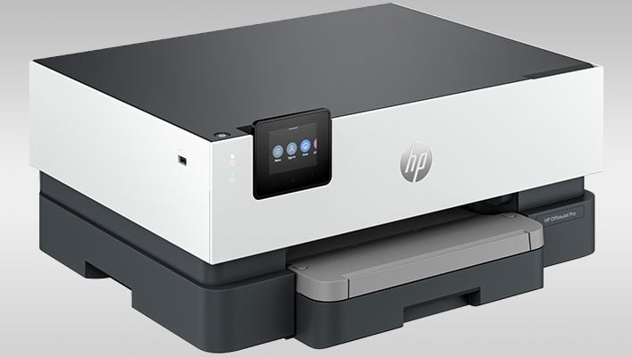 Angled view of an HP OfficeJet Pro 9110b wireless printer on a gray gradient background.