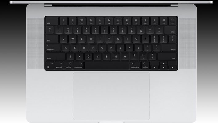 Widok z góry klawiatury 16-calowego MacBooka Pro Apple M3 (model srebrny) na czarno-szarym gradientowym tle.