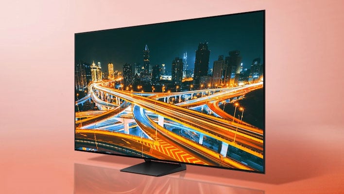 Angled render of Samsung's S85D OLED TV on a light orange gradient background.