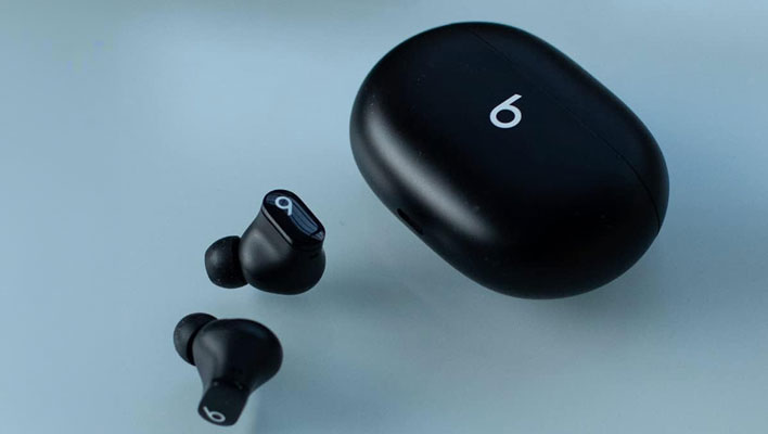 Beats Studio Buds on a light blue background.