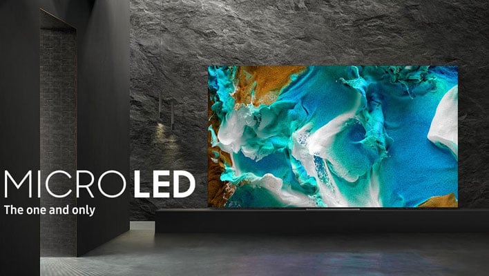 Samsung micro LED TV in front of a stone wall.