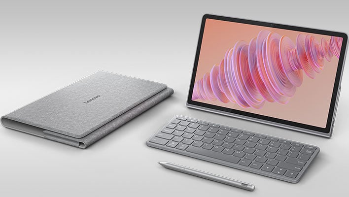 Lenovo Tab Plus with accessories on a gray gradient background.