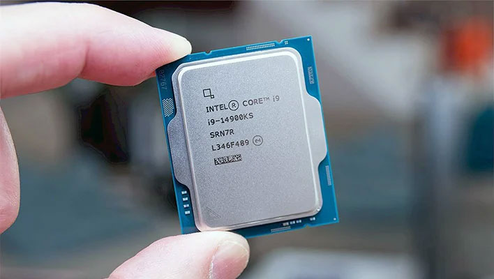 Fingers holding an Intel Core i9-14900KS processor.