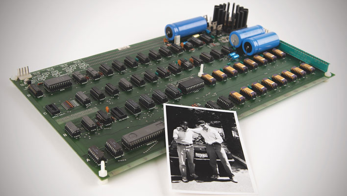 Apple-1 computer with a photograph leaning against it.