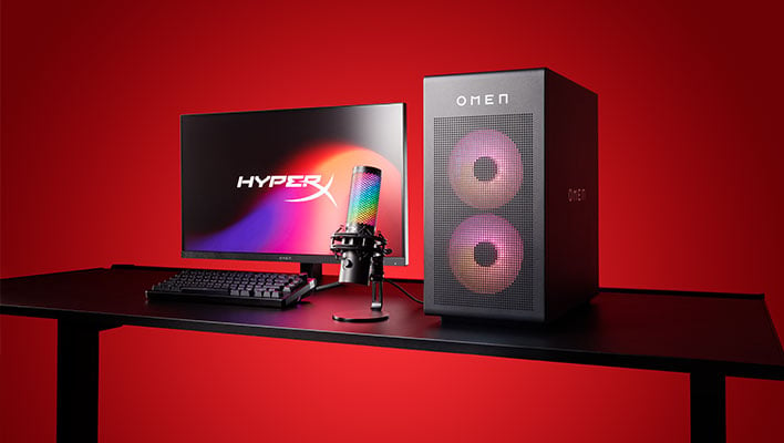 HP Omen 35L gaming PC, HyperX QuadCast S microphone, keyboard, and monitor on a desk in front of a red background.