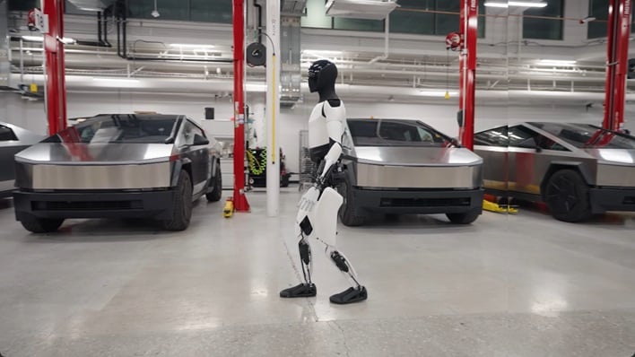 hero tesla optimus humanoid robot walking in plant