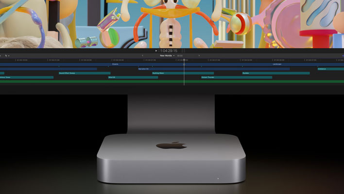 Apple Mac mini in front of a Studio Monitor.
